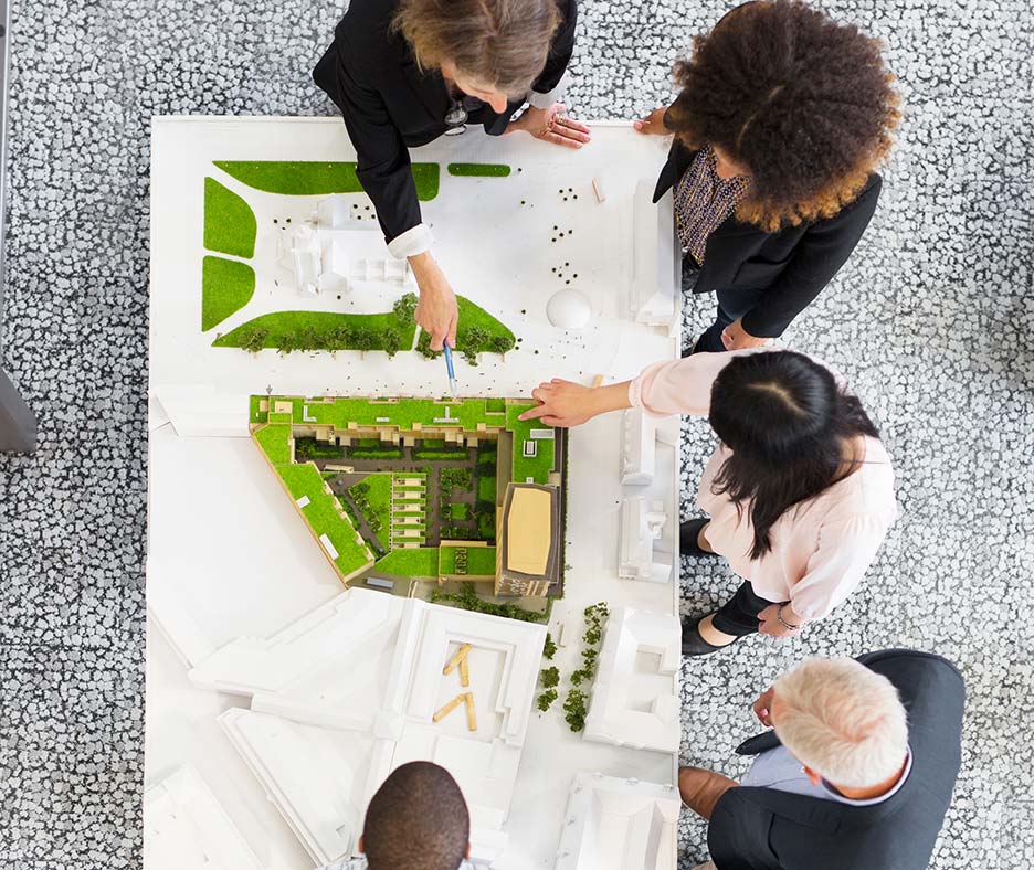 architecture group looking at plans on table