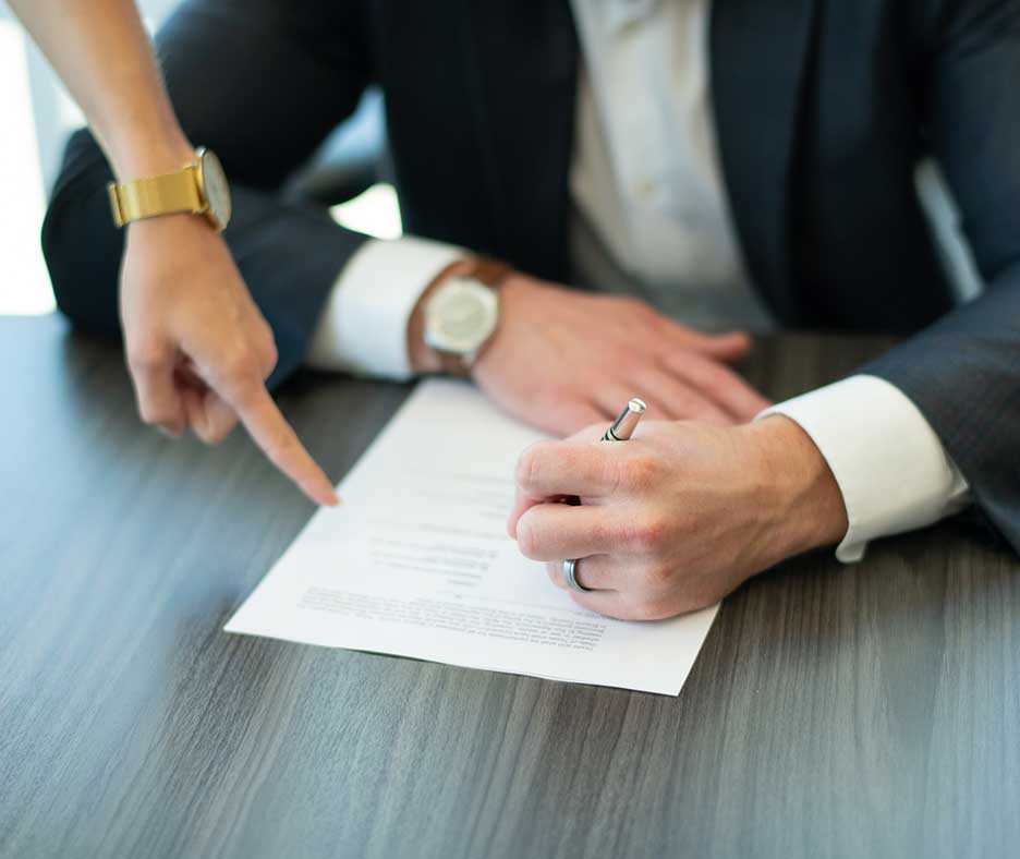 man in suit signing contract